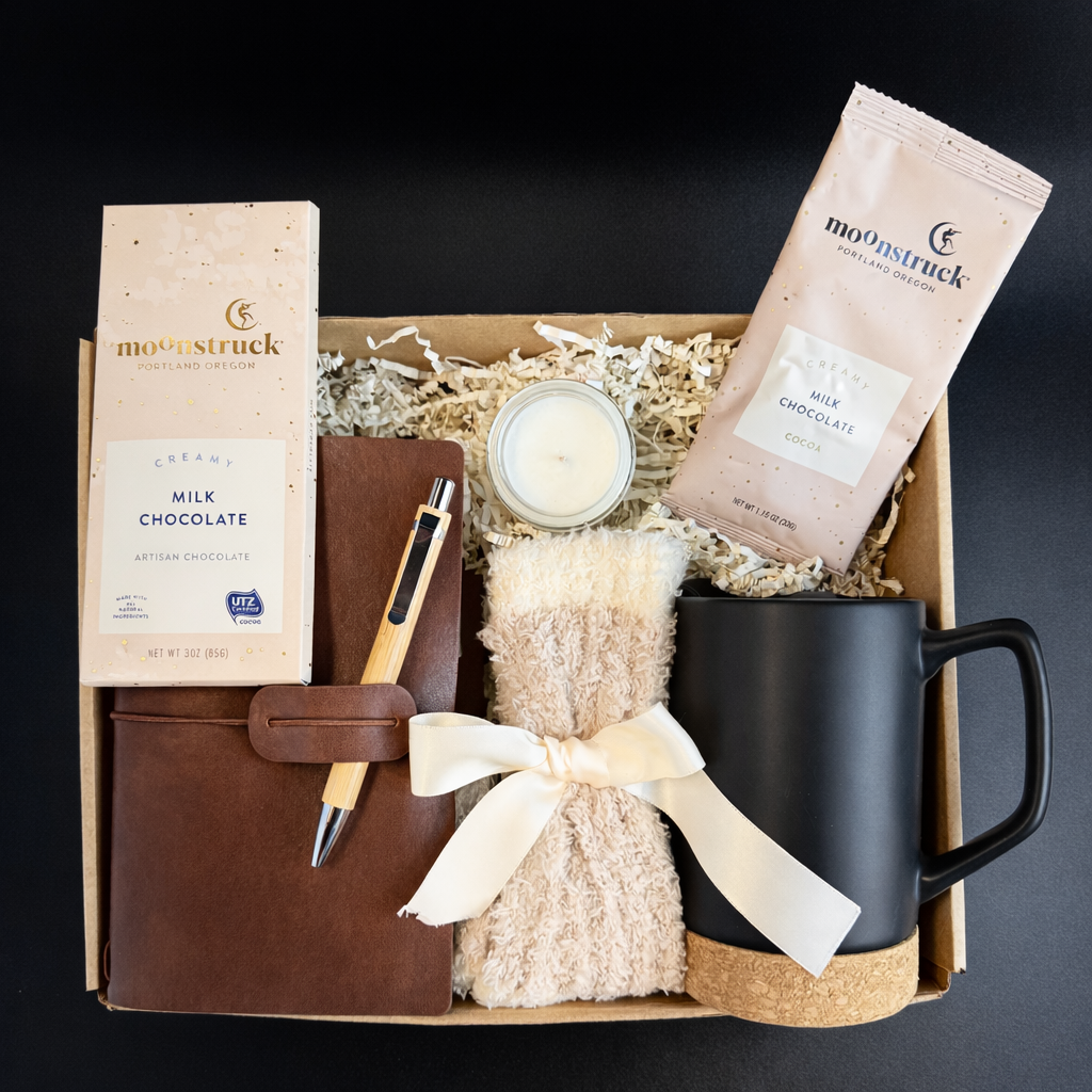 Gift box with chocolate, mug, candle, and other items on a dark background